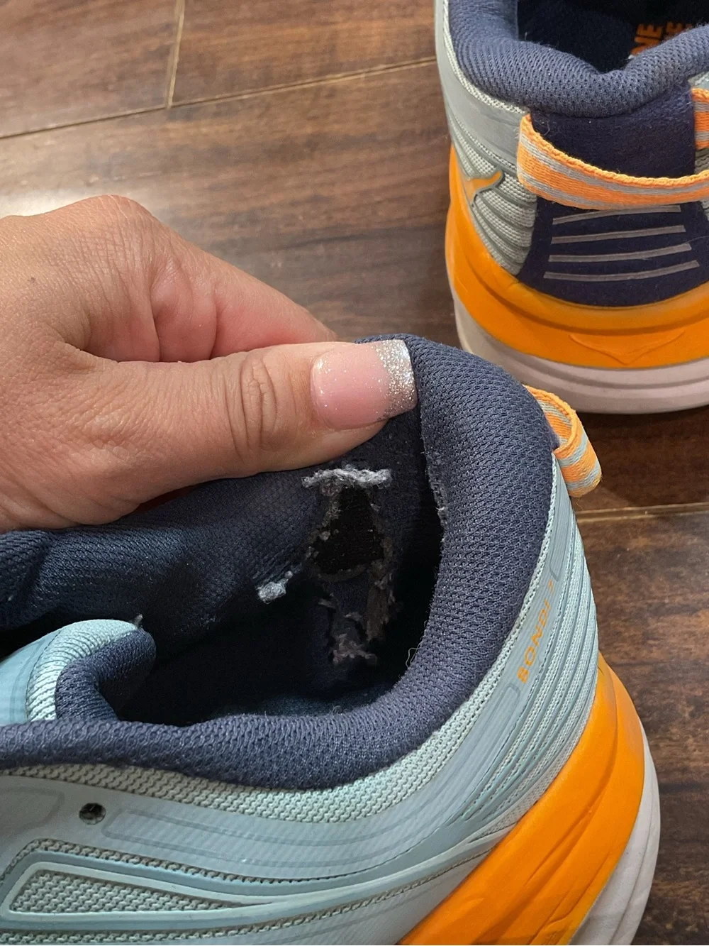 Hoka Blue Athletic Shoes with Orange and Pink Accents